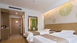 A hotel room with two beds, a wooden headboard, a coffee machine, and a bathroom visible through a glass door. - Greentree Inn Changzhou Zhongwu Avenue Jiangsu Uni (Changzhou)