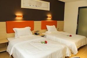 A hotel room with two beds, each with a white bedspread and pillows, and a single red rose on one bed. - 7 Days Premium Shanghai International Automobile City Tongji University Branch (Shanghai)