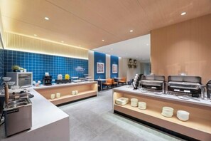 A modern hotel lobby with a reception desk, seating area, and buffet setup. - Jinjiang Inn (Wuxi New District National Software Park) (Wuxi)
