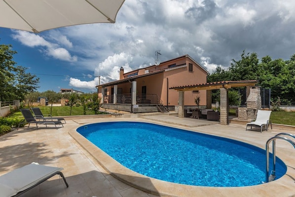 Outdoor pool, a heated pool, pool umbrellas, sun loungers