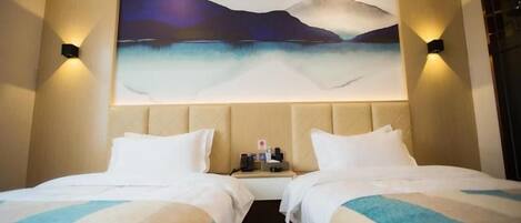 A hotel room with two beds, a painting on the wall, and a nightstand with a lamp.