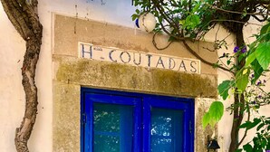 A blue door with a sign above it that reads "H. COUTADAS". - Monte Alentejano T5 Private Pool (Portalegre)