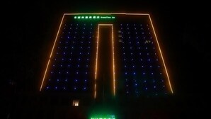 A hotel with a distinctive star-shaped facade and a green sign indicating it is a GreenTree Inn. - Greentree Inn Fuyang Exhibition Center (Fuyang)