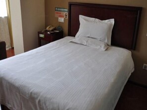 Restful retreat with a large bed and a convenient nightstand.