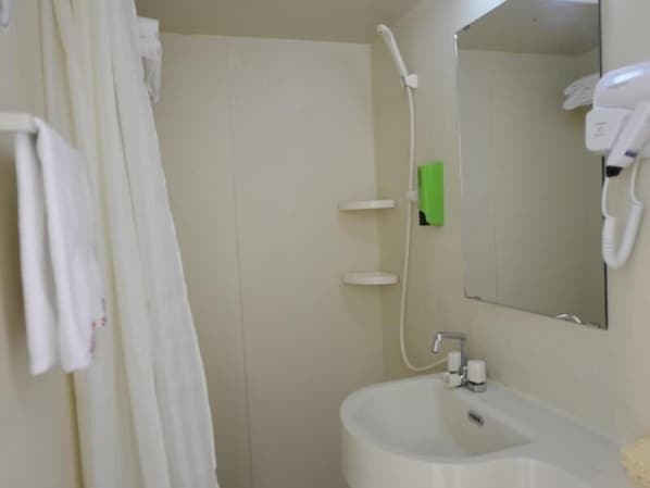 A bathroom with a white sink, a mirror, a shower, and a towel hanging on the wall. - Shell Shengyang Huanggu District The Yalv River Yi (Shenyang)