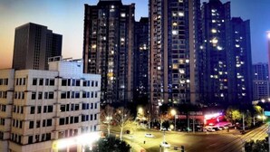 A high-rise residential building complex at night with illuminated windows and streetlights. - Baiyi Hotel (Ji'an Municipal Government Branch) (Ji'an)