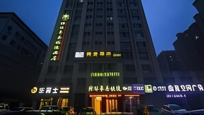 A multi-story building with illuminated signage, likely a hotel or commercial property. - Greentree Inn Weifang Kuiwen District Beiwang Jial (Weifang)