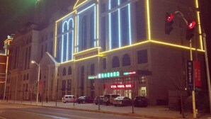A building with illuminated signage, including a hotel and a restaurant. - Greentree Inn Luoyang Train Station Zhuangyuanhong (Luoyang)