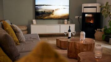A living room with a television, a fireplace, and a sofa.