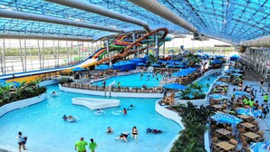 An indoor water park with multiple pools, slides, and a large water slide. - Staybridge Suites Dallas Grand Prairie by IHG (Grand Prairie)