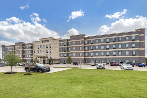 Stunning hotel building with a modern design, featuring a combination of brick and stone facades and a flat roof.