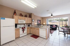 Enjoy cooking in this well-equipped kitchen with appliances and a dining area.