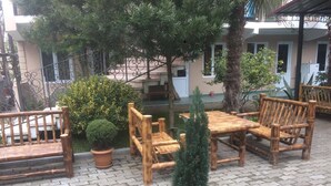 An outdoor seating area with wooden furniture and potted plants. - Gio 350 (Kobuleti)