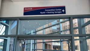 A hotel entrance with a sign indicating the convention center, Hyatt, and parking garages. - 360° TERRACE VIEW KING BEDS SELF CHECK-IN WIFI W/D (Indianapolis)