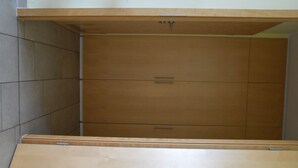 A room with a wooden cabinet and a large wooden table. - Vacation apartment in the heart of Berlin ( City West ) (Berlin)