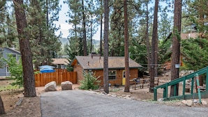 A cabin with a wooden exterior, a front porch, and a staircase leading to a deck. - JUST FOR 2!  NEAR ENTERTAINMENT/RESTAURANTS - HOT TUB - FIRE PIT - BBQ & A/C (Big Bear Lake)