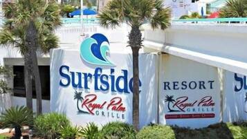 A sign for 'Surfside Resort' with 'Royal Palm Grill' written below.