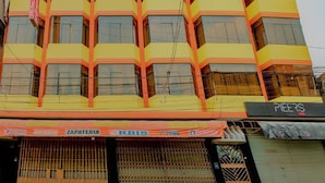 A multi-story building with a sign reading "HOSTAL ORBIS" at the top. - Hospedaje Orbis (Pichanaqui)