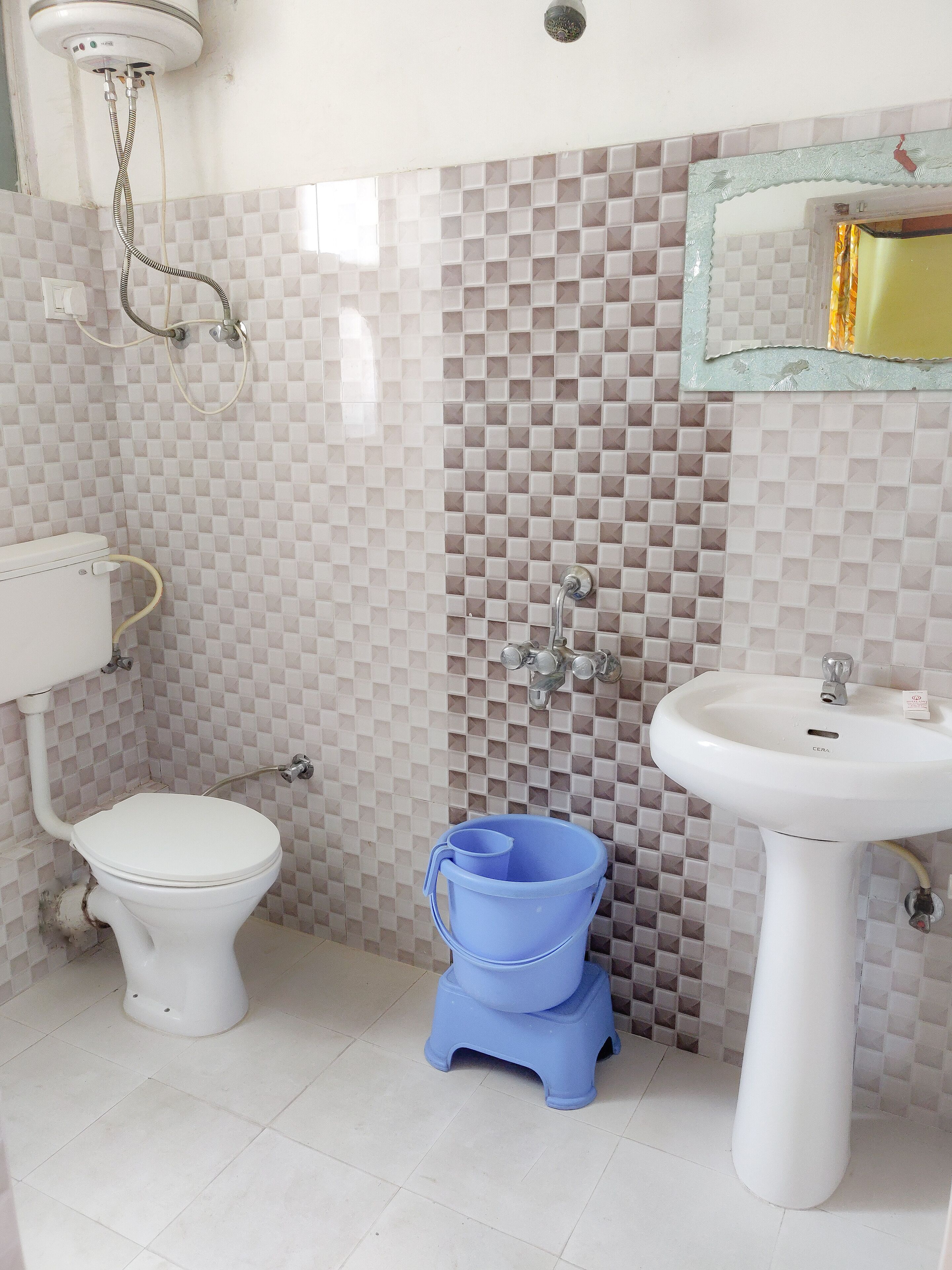 A bathroom with a toilet, a sink, and a shower.