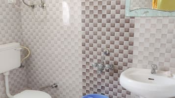 A bathroom with a toilet, a sink, and a shower.