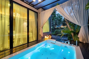 A modern bathroom with a large bathtub, a glass shower enclosure, and a view of the outdoors. - At Rice Resort (Nakhon Nayok)
