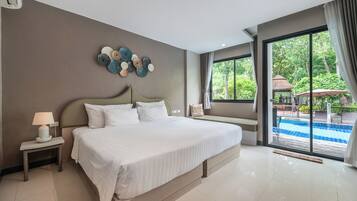A modern hotel room with a large bed, a bedside table with a lamp, a decorative wall piece, and a view of an outdoor swimming pool.
