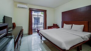 A hotel room with a bed, a desk with a TV, a chair, and a balcony with curtains. - Plaza 68 Residence (Jakarta)