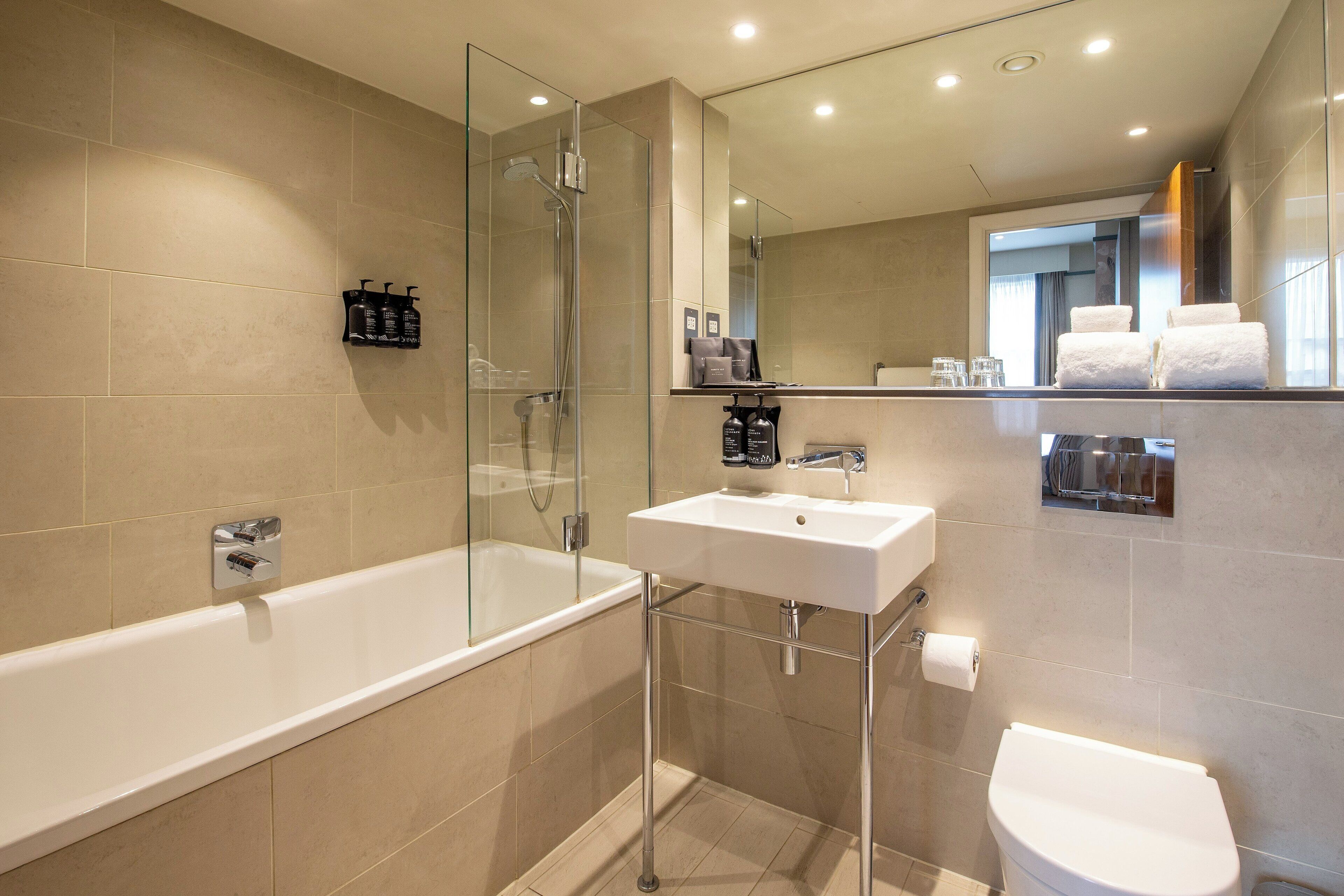 charleston 1 bedroom apartment | bathroom | rainfall showerhead, hair dryer, bathrobes, slippers