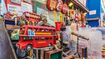 A collection of vintage toys and collectibles, including a red double-decker bus and various other items.