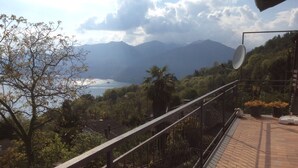 A balcony with a view of mountains, a lake, and a satellite dish. - SUNNY VACATION APARTMENTS IN A QUIET LOCATION WITH A FANTASTIC LAKE VIEW (DUE COSSANI Luino Piemont)