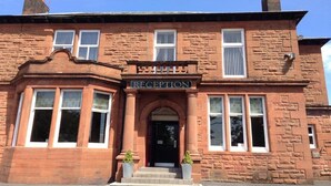 A red brick building with a 'RECEPTION' sign above the entrance. - The Douglas Hotel (Kilmarnock)