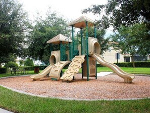 Explore the central play tower with a roofed climbing area and two slides in this park setting.