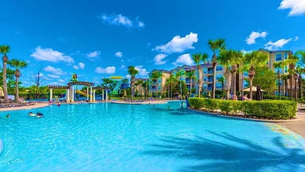 A large swimming pool surrounded by palm trees and a gazebo. - Welcome to The Windsor Fantasy with Brand New Professional Arcade Room! (Kissimmee)