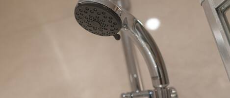 A showerhead with a circular design and multiple nozzles.
