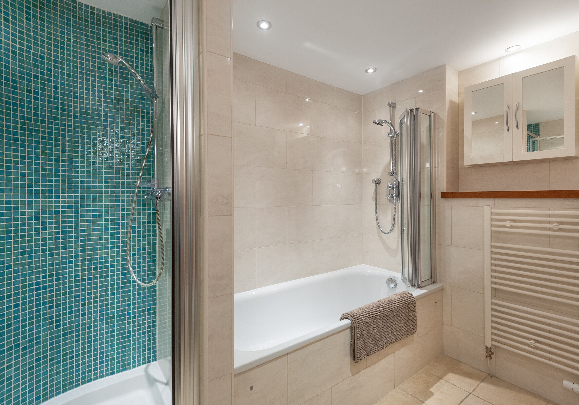 A modern bathroom with a glass-enclosed shower, a standalone bathtub, and a built-in toilet.