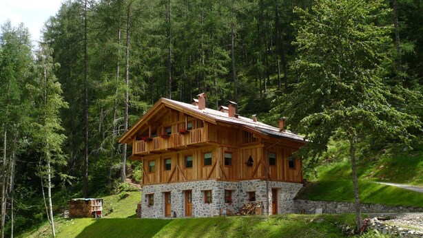 A two-story wooden cabin with stone foundation, surrounded by dense forest. - MAS DE LA BOLP,  MOUNTAIN CHALET (Rabbi)
