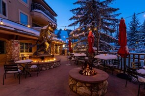 An outdoor patio with stone seating, a fire pit, and a statue. - Charlie Rentz: Best Location BC Village! Creekside Unit, Walk to Lifts, Ski School, Dining (Beaver Creek)