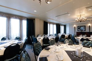 A hotel dining room with round tables, black upholstered chairs, and chandeliers. - Charlie Rentz: Best Location BC Village! Creekside Unit, Walk to Lifts, Ski School, Dining (Beaver Creek)