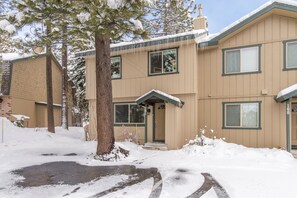 A two-story building with a snow-covered exterior and a visible front entrance. - Walk to the lake (Tahoe City)