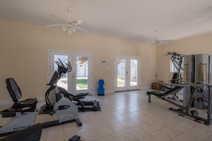 Work out in comfort with a fully equipped gym featuring a stationary bike, elliptical trainer, and weight machines.