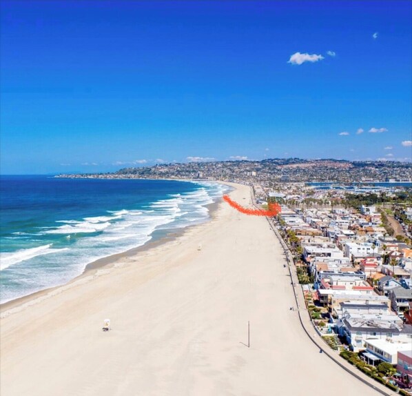 Stroll along the wide sandy beach and enjoy the scenic views of the coastal town.
