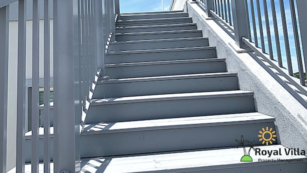 A staircase with metal railings leading to a higher floor.