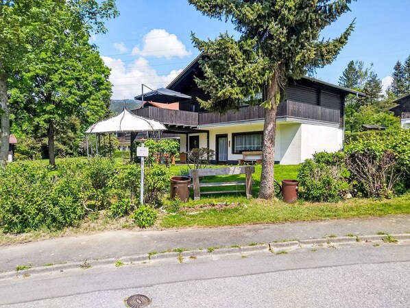 A two-story house with a balcony, a covered patio, and a well-maintained garden. - Am Hohen Bogen by Interhome (Arrach)