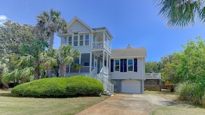 A two-story house with a covered porch and a garage. - 8 44th Avenue (Isle of Palms)