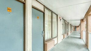 A long corridor with doors numbered 208 and 207, leading to rooms. - RW Hotel (Kissimmee)