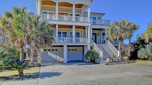 A multi-story building with a central staircase, balconies, and a covered front porch. - 2603 Palm Boulevard (Isle of Palms)