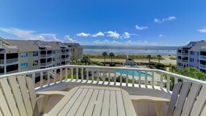 A balcony with a view of a beach and ocean. - H303 Tidewater (Isle of Palms)