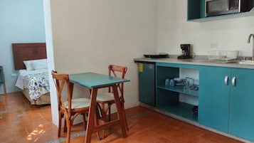 Luxury Studio Suite | Private kitchen | Mini-fridge, microwave, coffee/tea maker, cleaning supplies