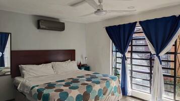 Comfort Room | Down comforters, desk, laptop workspace, blackout drapes