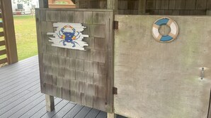Een houten constructie met een geschilderde krabversiering en een drijvend reddingsmiddel aan de zijkant.